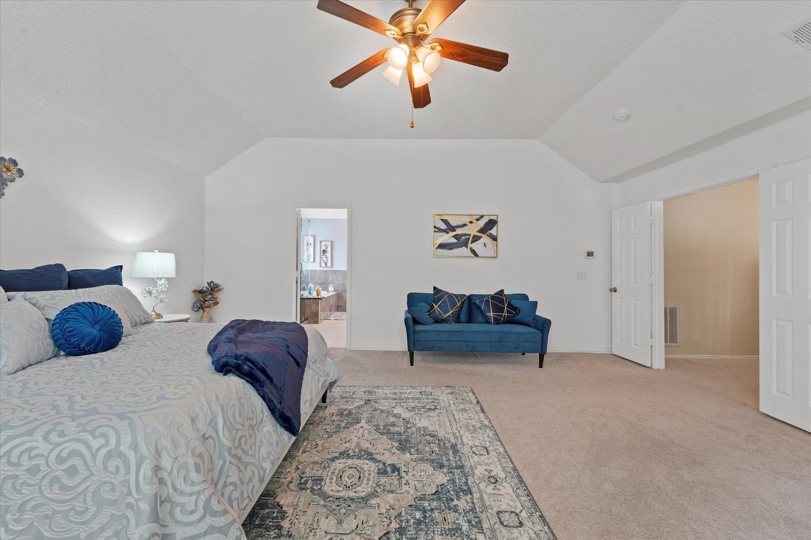 Vi'Lou staged primary bedroom with blue accents